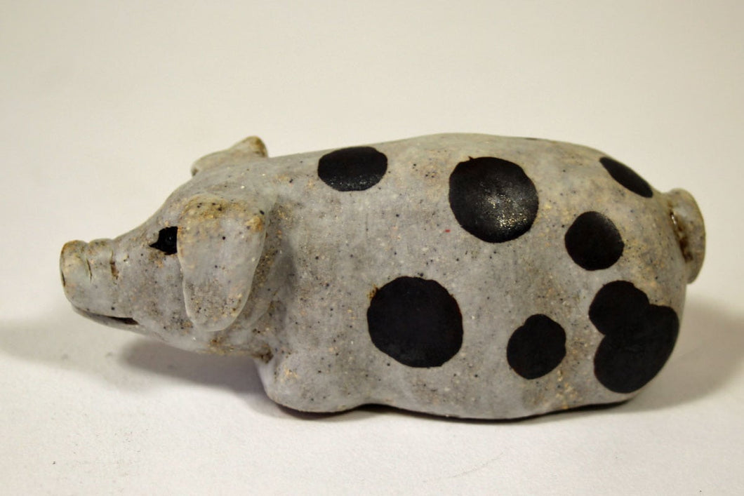 A Small White Spotty Stoneware Pig
